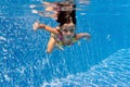 Happy underwater kid in swimming pool