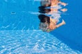 Happy underwater kid in swimming pool