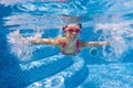 Happy underwater kid in swimming pool