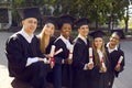 Happy graduates celebrate their graduation and rejoice at successful completion of their studies. Royalty Free Stock Photo