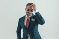 Happy unshaved man in suit with retro sunglasses adjusting hair Royalty Free Stock Photo