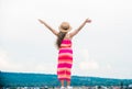 Happy vacation. Cute girl in summer dress and hat outdoors sky background. Enjoying relax. Child happy small girl. Free