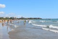 Happy vacation on  seaside. people walk along  seashore Royalty Free Stock Photo