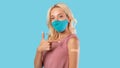 Happy Vaccinated Female In Face Mask Pointing At Arm Royalty Free Stock Photo