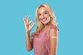 Happy Vaccinated Female Showing Shoulder With Patch And Okay Sign Royalty Free Stock Photo