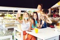 Happy vaccinated young girl friends taking selfie at cocktail party at trendy pub restaurant