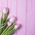 Happy Valentine`s Day. Valentine`s day background. Pink tulips and heart on a pink background. Top view, free space Royalty Free Stock Photo