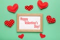 Happy valentine`s day card, frame and red hearts on green background