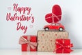 Happy Valentine`s Day card. Red retro toy car with plush heart