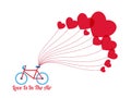 Happy valentine`s day concept of love. Bicycle with heart shape balloons and word ` Love is in the air`.