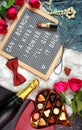 Valentine`s Day flat lay with roses, champagne and letterboard. Royalty Free Stock Photo