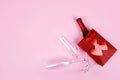 Happy Valentine's Day flatlay. Top view bottle of rose champagne in gift box, hearts, glasses on soft pink background Royalty Free Stock Photo