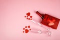 Happy Valentine's Day flatlay. Top view bottle of rose champagne in gift box, hearts, glasses on soft pink background Royalty Free Stock Photo