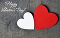 Happy Valentine`s Day greeting card.Decorative red and white wooden hearts on a grey wooden background. Royalty Free Stock Photo