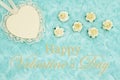 Happy Valentine`s Day greeting with a heart with lace on pale teal rose plush fabric