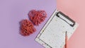 Happy Valentine's Day. notebook with a pen for writing a greeting text and two rattan hearts are symbols of love Royalty Free Stock Photo