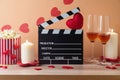 Happy Valentine\'s day and romantic movie concept with movie clapper board, heart shapes, wine and popcorn Royalty Free Stock Photo