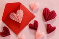 Happy Valentine`s day! Stylish pink hearts and red envelope flat lay on pink paper background. Modern Valentines day composition.