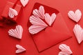 Happy Valentine`s day! Stylish red envelope with pink hearts and gift flat lay on red paper background. Modern valentine card wit Royalty Free Stock Photo