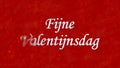 Happy Valentine's Day text in Dutch Fijne Valentijnsdag turns to dust from left on red background Royalty Free Stock Photo