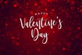 Happy Valentine`s Day Text Over Red Sparkle Glitter. Magical Holiday Calligraphy with Glowing Defocused Bokeh Lights Background.