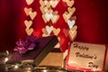 Happy Valentine`s day writing on card with open gift box on heart shaped bokeh lights Royalty Free Stock Photo