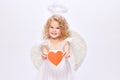 Happy Valentine& x27;s Day. Little baby cupid, beautiful girl in white dress holding paper heart isolated over white