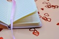 empty notebook between hearts confetti Royalty Free Stock Photo