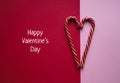 Happy Valentines Day banner with sweet striped candy canes in heart shape on red and pink background