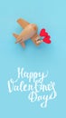 Happy Valentines day. Eco wooden children's plane on a blue background Royalty Free Stock Photo