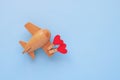 Happy Valentines day. Eco wooden children's plane on a blue background Royalty Free Stock Photo