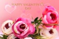 Happy Valentines Day greeting card. Decorative bouquet of colorful artifical roses over abstract pink bokeh hearts background Royalty Free Stock Photo