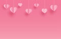 Happy valentines day greeting cards with paper hearts hanging on pink pastel background