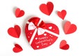 Happy valentines day, heart shape gift box with ribbon and small paper hearts with written note, on white background, top view