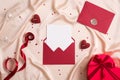 Happy Valentines Day Romantic Letter Concept. Red envelope with blank paper card inside, heart-shaped gift box, ribbon, hearts Royalty Free Stock Photo