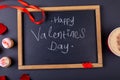 Happy valentines day text on writing slate by cupcakes and coffee cup on table Royalty Free Stock Photo