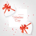 Happy Valentines Day. Two Heart shaped white Gift Box tied with Red Ribbons with a Bow on white frame with Hearts Confetti. Top Royalty Free Stock Photo