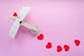 Happy Valentines day. wooden children`s plane on a pink background with red heart, and garland in the shape of a heart Royalty Free Stock Photo