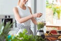 Happy vegan woman mixing vegetables