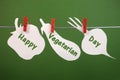Happy Vegetarian Day message greeting written across vegetable cards hanging from pegs on a line