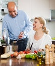 Happy vegetarian family cooking vegetables