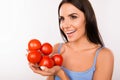 Happy vegetarin woman with tomatoes Royalty Free Stock Photo