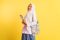 happy veiled high school student girl carrying bag and book Royalty Free Stock Photo