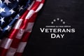 Happy Veterans Day. American flags veterans against a blackboard background