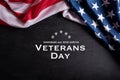 Happy Veterans Day. American flags with the text thank you veterans against a blackboard background. November 11 Royalty Free Stock Photo