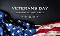 Happy Veterans day concept with flag of the United States and the text on black wooden background Royalty Free Stock Photo