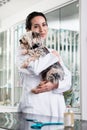Happy veterinarian carrying sick puppy