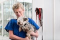 Happy veterinarian carrying sick puppy