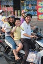 Happy Vietnamese family on motorcycle