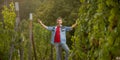 happy vineyard owner presenting his winery with grape harvest, happiness